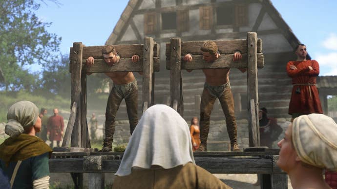 Screenshot from Kingdom Come Deliverance 2 showing two shirtless men in stocks