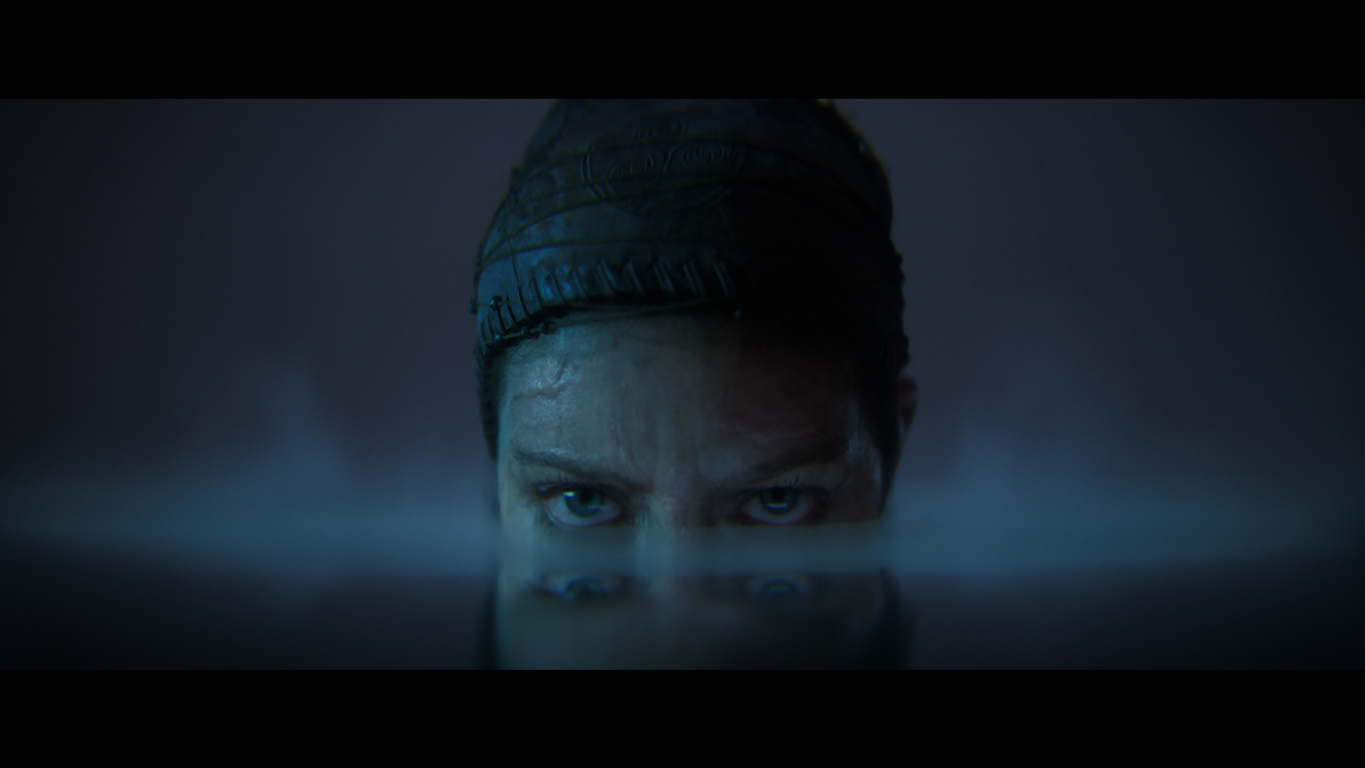 Senua lurks menacingly in a pool of still water in a Senua&rsquo;s Saga: Hellblade 2 cinematic.