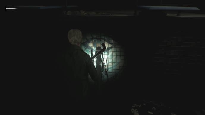 James looking at an eye symbol printed on a pool, with black ooze coming from a hole in it in Silent Hill 2.