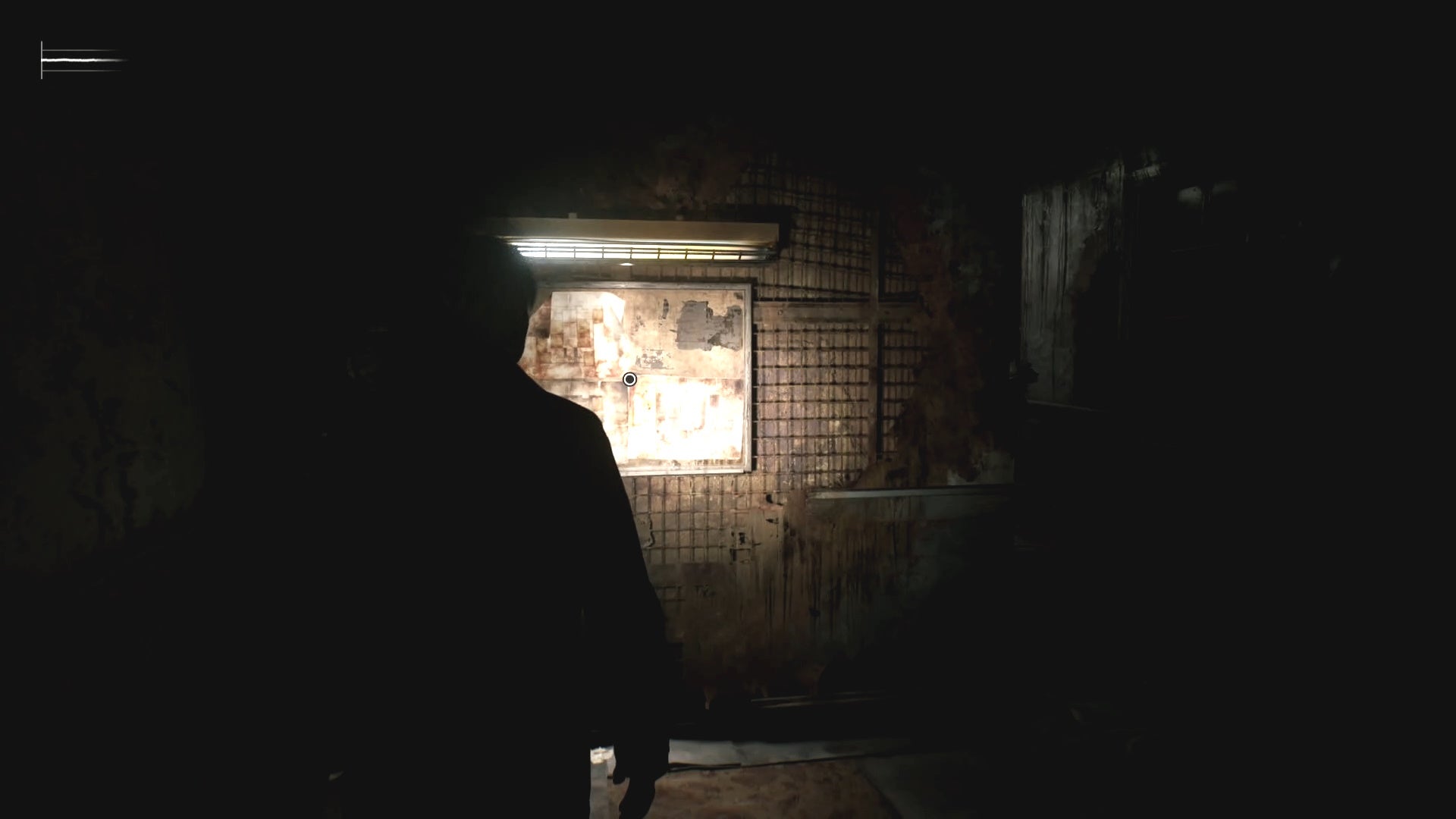 James looking at maps on a wall at Blue Creek Apartments in Silent Hill 2.