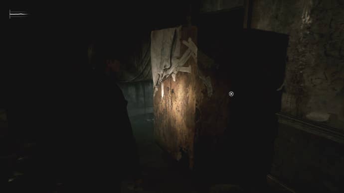 A dilapidated cabinet against a wall in Silent Hill 2.