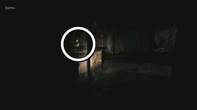 A white circle showing the Pigeon Figurine inside a broken cabinet in Silent Hill 2.