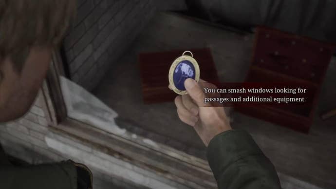 James holds the Blue Gem after retrieving it from the Jeweler’s storefront in East South Vale in the Silent Hill 2 remake