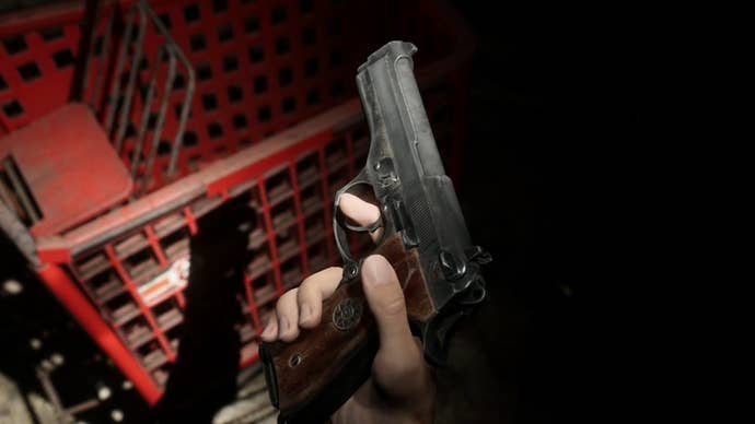 James holding the Handgun near a red shopping cart in Silent Hill 2.