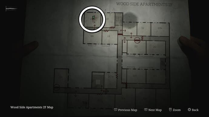 A white circle showing the location of the Handgun in Room 217 of Wood Side Apartments in Silent Hill 2.
