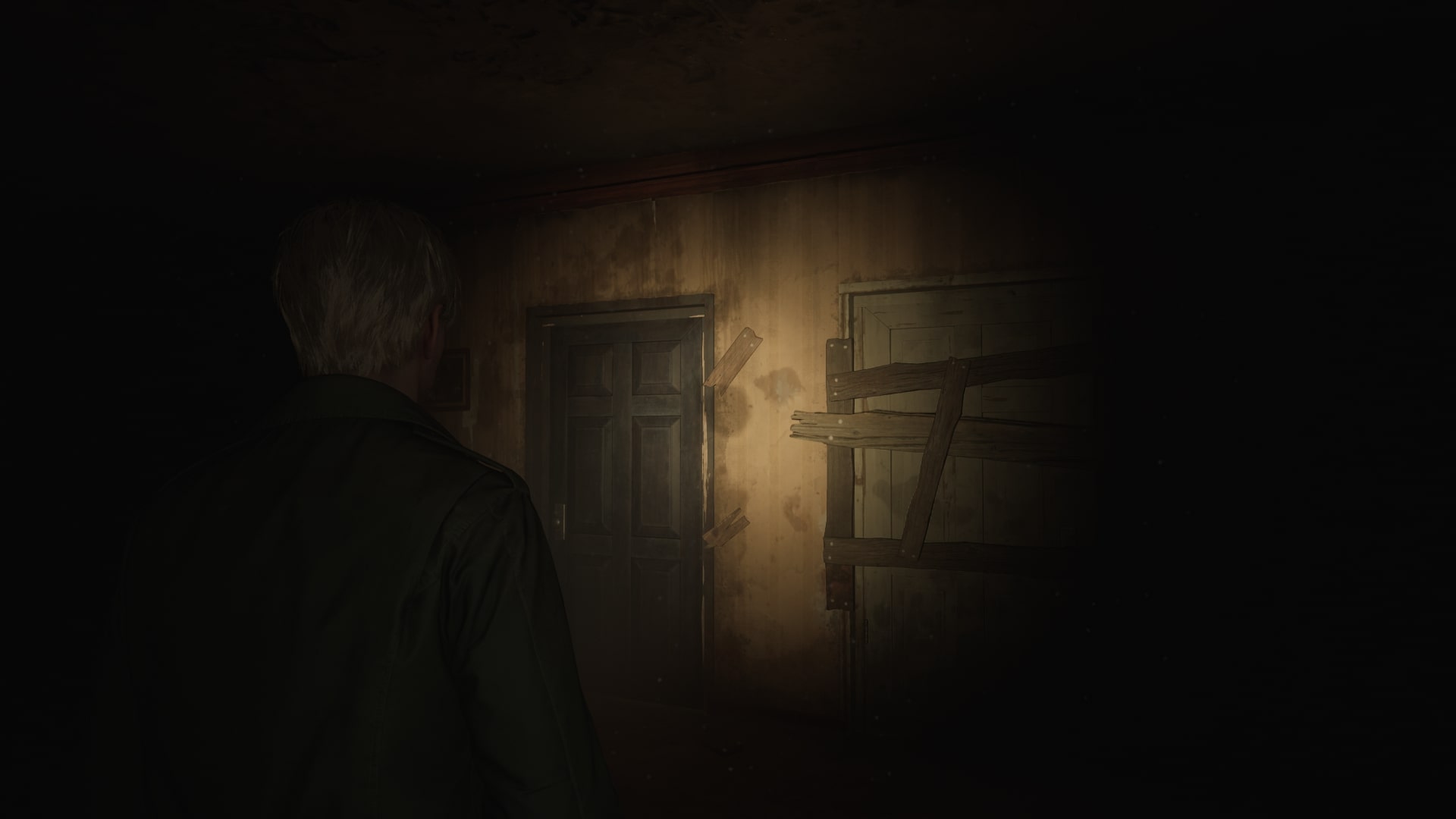 James approaches a black door in the Labyrinth in the Silent Hill 2 remake - 1