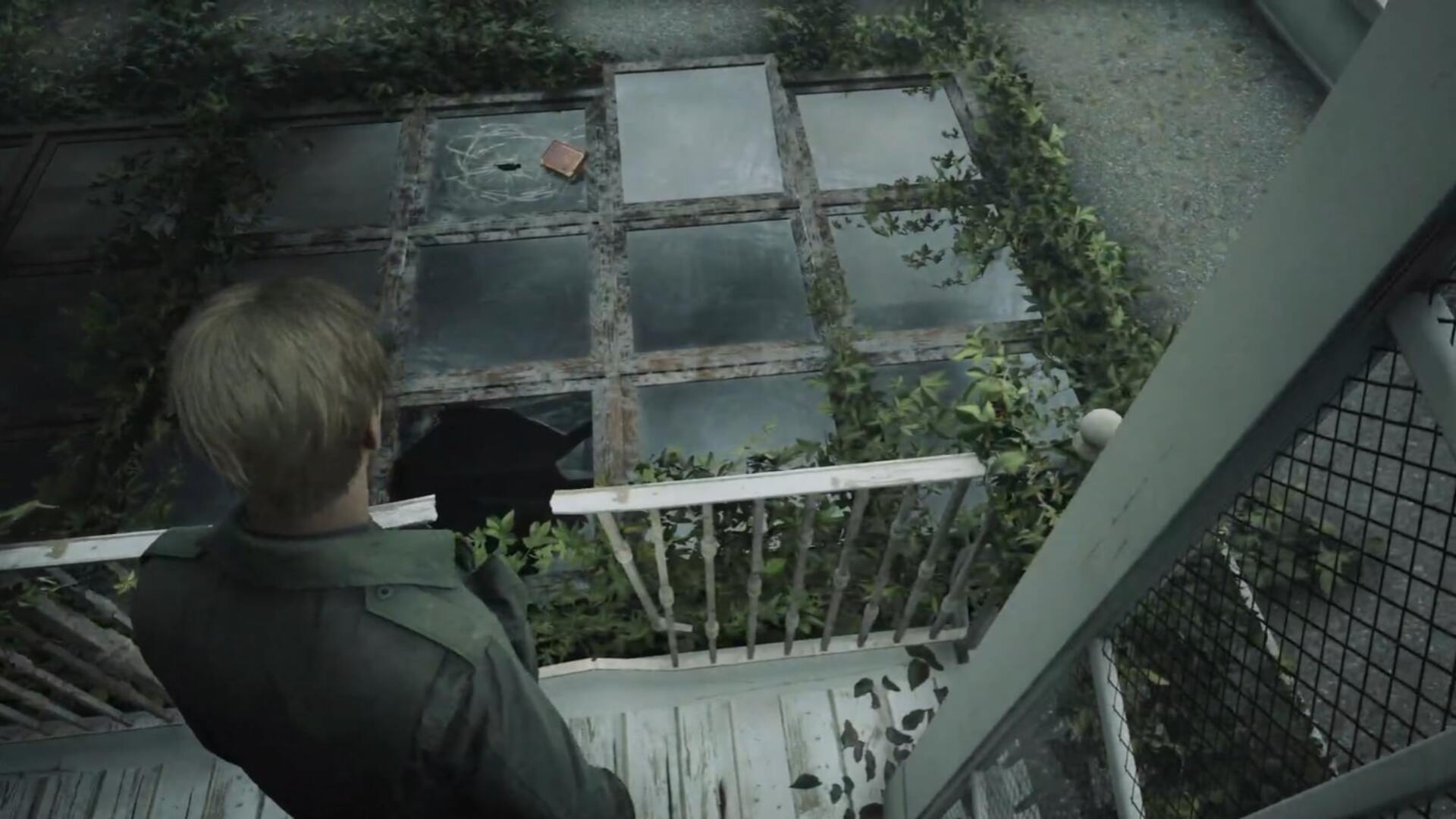James looks at a book that is laying on a broken skylight in Lake View Hotel in the Silent Hill 2 remake - 4
