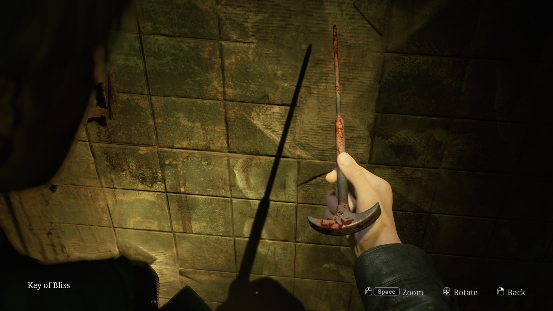 James retrieves the Key of Bliss from a wall in the Otherworld Hospital in the Silent Hill 2 remake - 5