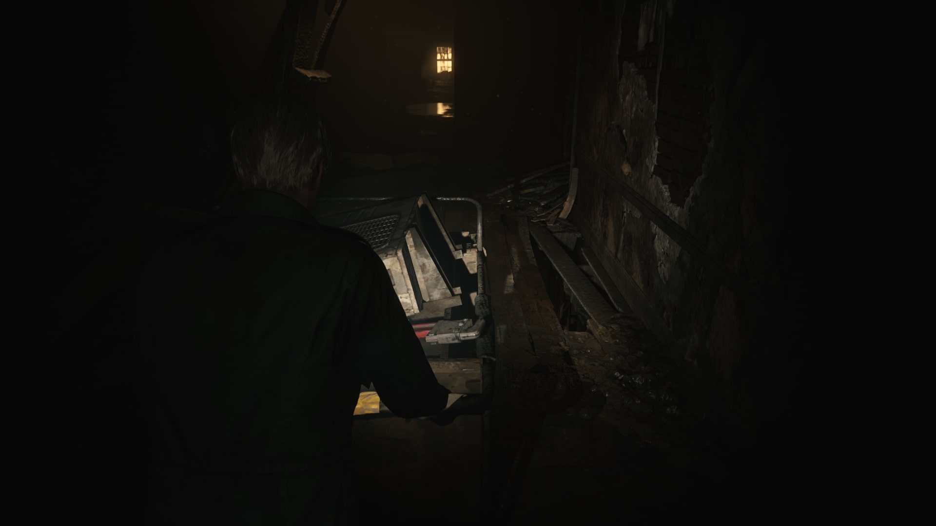 James moves a cart over some unsteady flooring in the Otherworld Hotel in the Silent Hill 2 remake