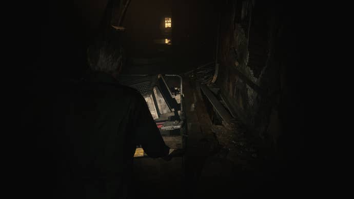 James moves a cart over some unsteady flooring in the Otherworld Hotel in the Silent Hill 2 remake