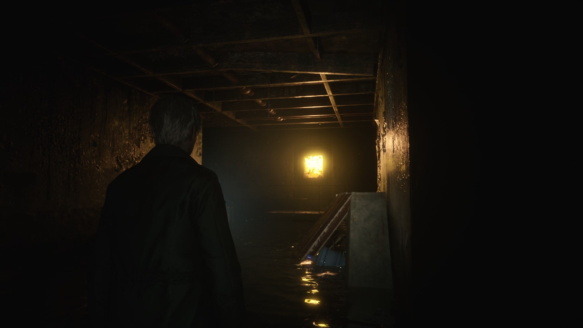 James looks at an illuminated, glowing door in the Otherworld&rsquo;s Hotel Basement in the Silent Hill 2 remake