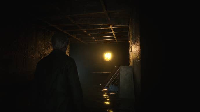 James looks at an illuminated, glowing door in the Otherworld’s Hotel Basement in the Silent Hill 2 remake