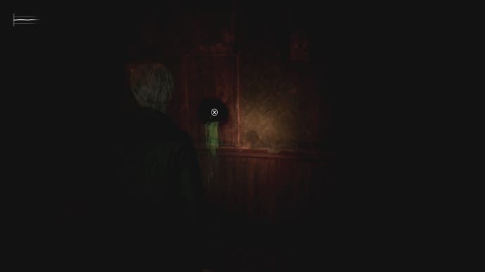 James looks at a hole in a wall with green liquid flowing from it in Silent Hill 2.