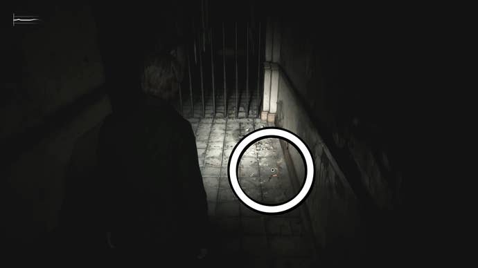 A white circle showing the 2F Hallway Key on the floor in Silent Hill 2.