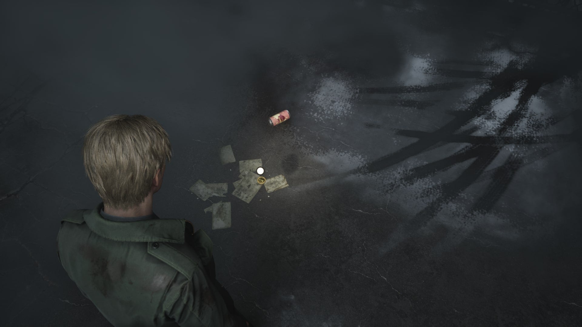 James retrieves one of three coins from the Courtyard of Wood Side Apartments in the Silent Hill 2 remake - 3