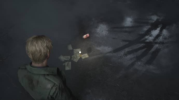James retrieves one of three coins from the Courtyard of Wood Side Apartments in the Silent Hill 2 remake