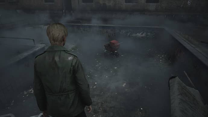 James looks over at a red pram in Wood Side Apartments in the Silent Hill 2 remake