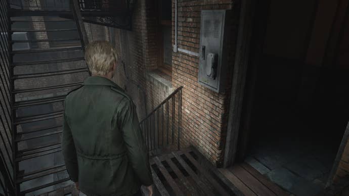 James stand beside a lever for the stairwell of Wood Side Apartments in the Silent Hill 2 remake