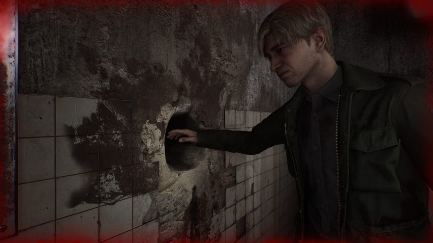 James nervously prepares to stick his hand in a mysterious hole in the wall the Silent Hill 2 remake.