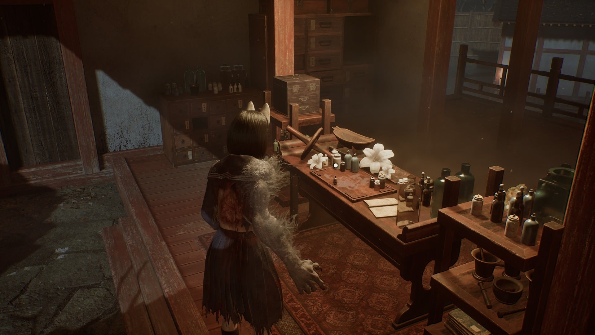 Hinako stands in front of a desk featuring the Hotei-Sama item in Silent Hill f