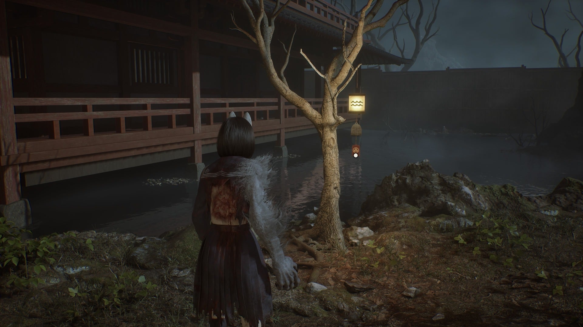 Hinako looks at a bell hanging from a tree with a water symbol on it in Silent Hill f