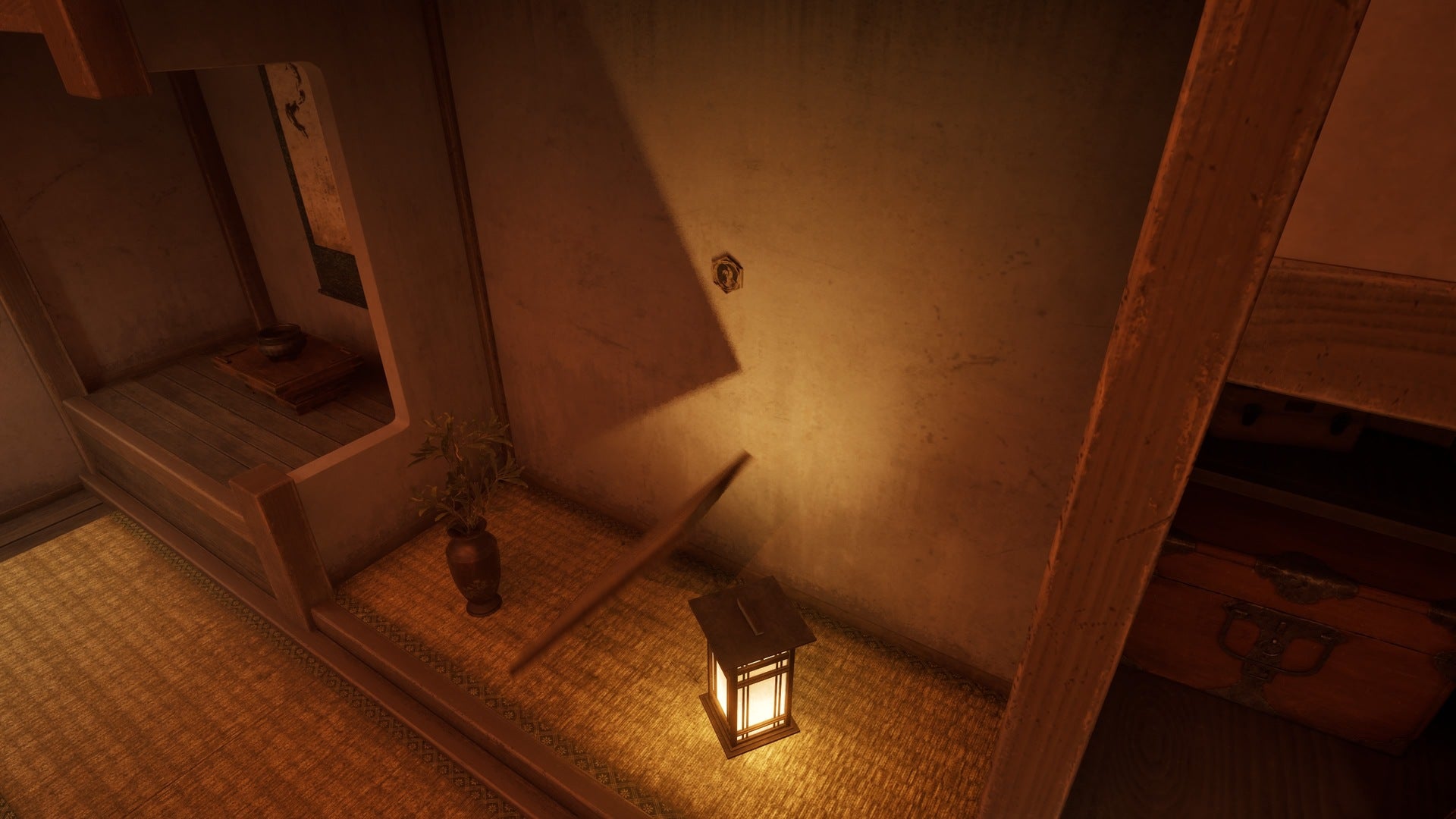 A picture can be seen having fallen from the wall onto a lantern, revealing a Crest behind it, in Silent Hill f