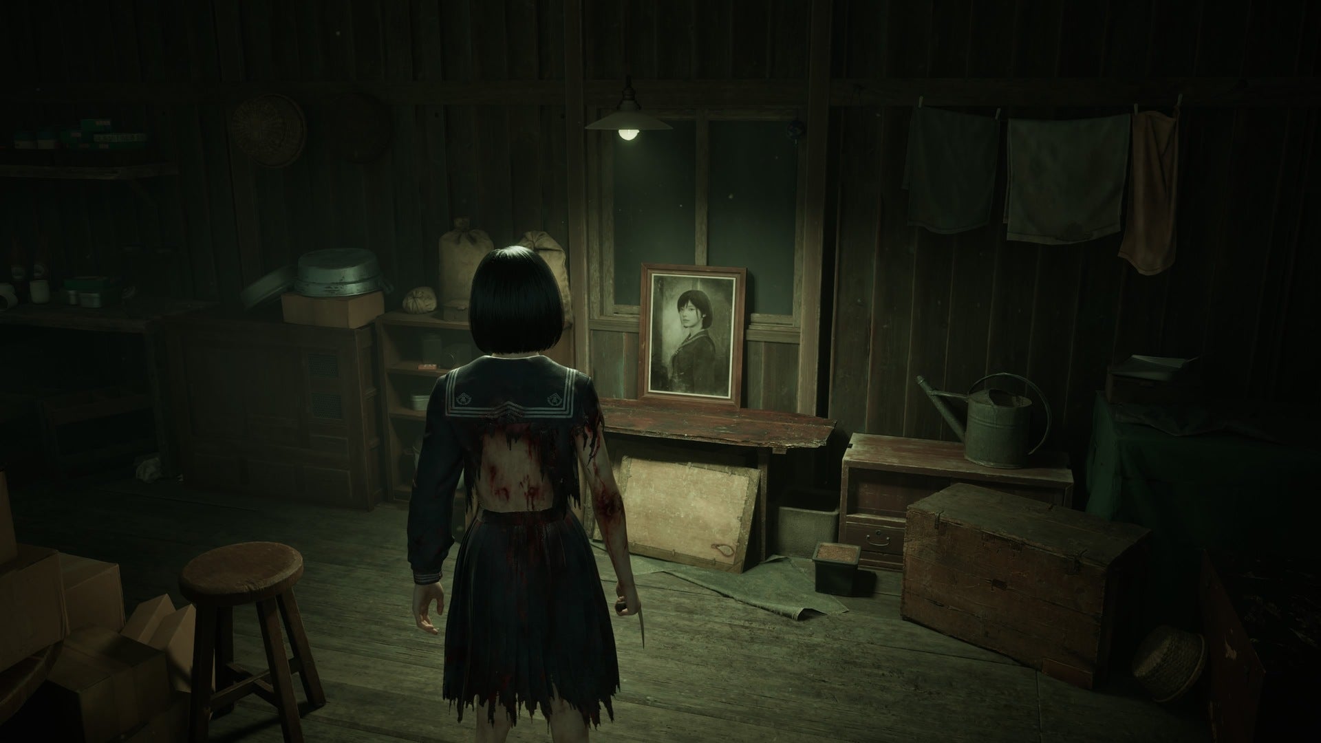 Hinako looks towards a framed picture of herself in Silent Hill f