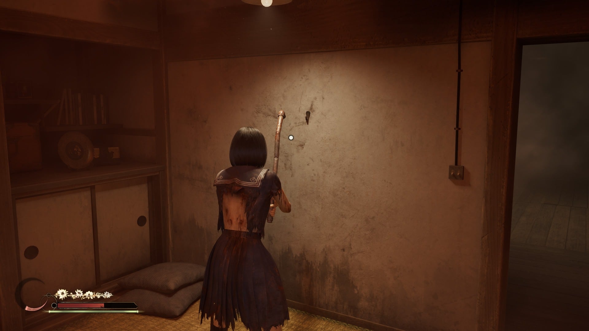 Hinako looks at the wall where a photograph is missing in Silent Hill f
