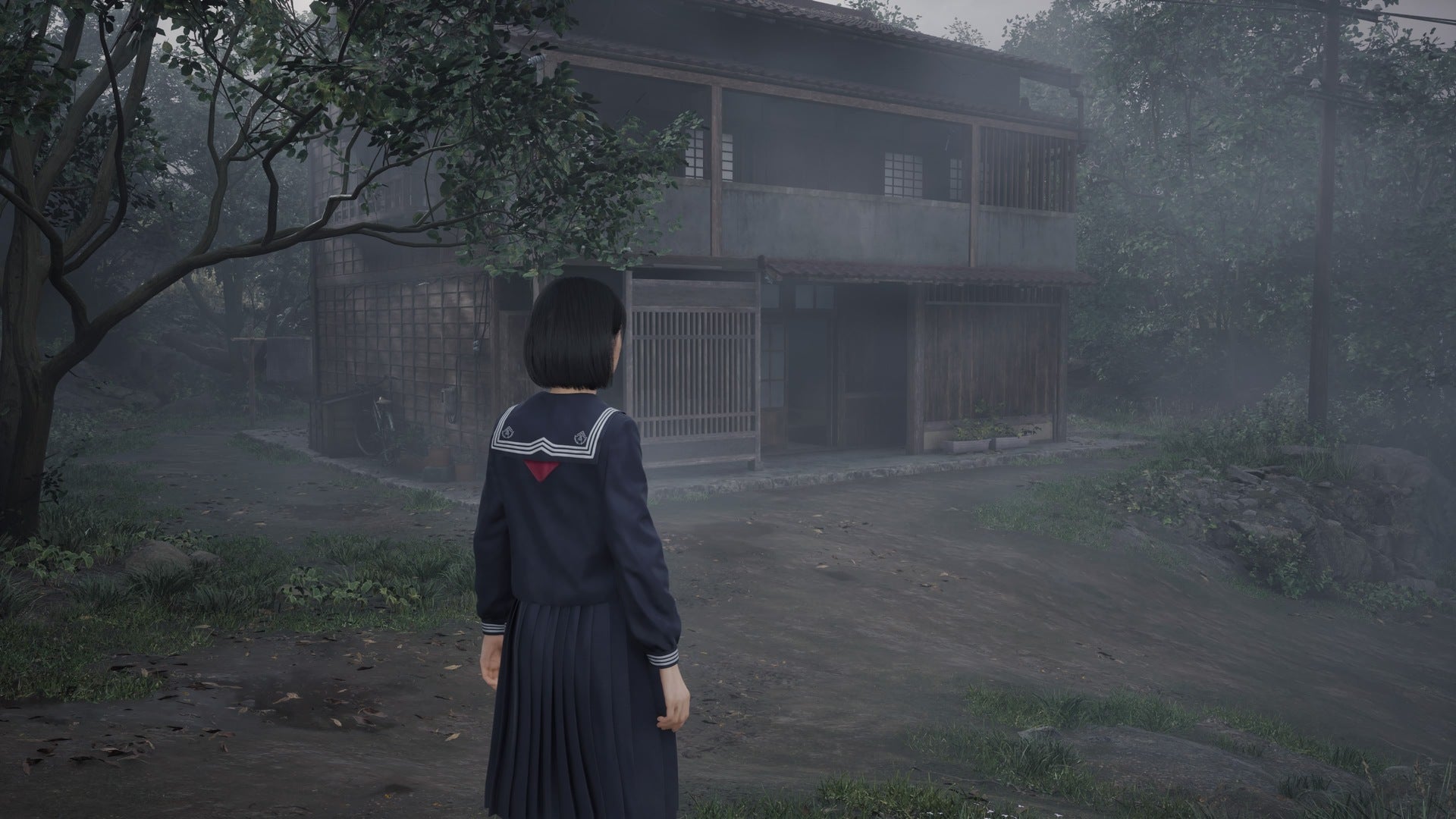 Hinako looks over at an open house in Silent Hill f