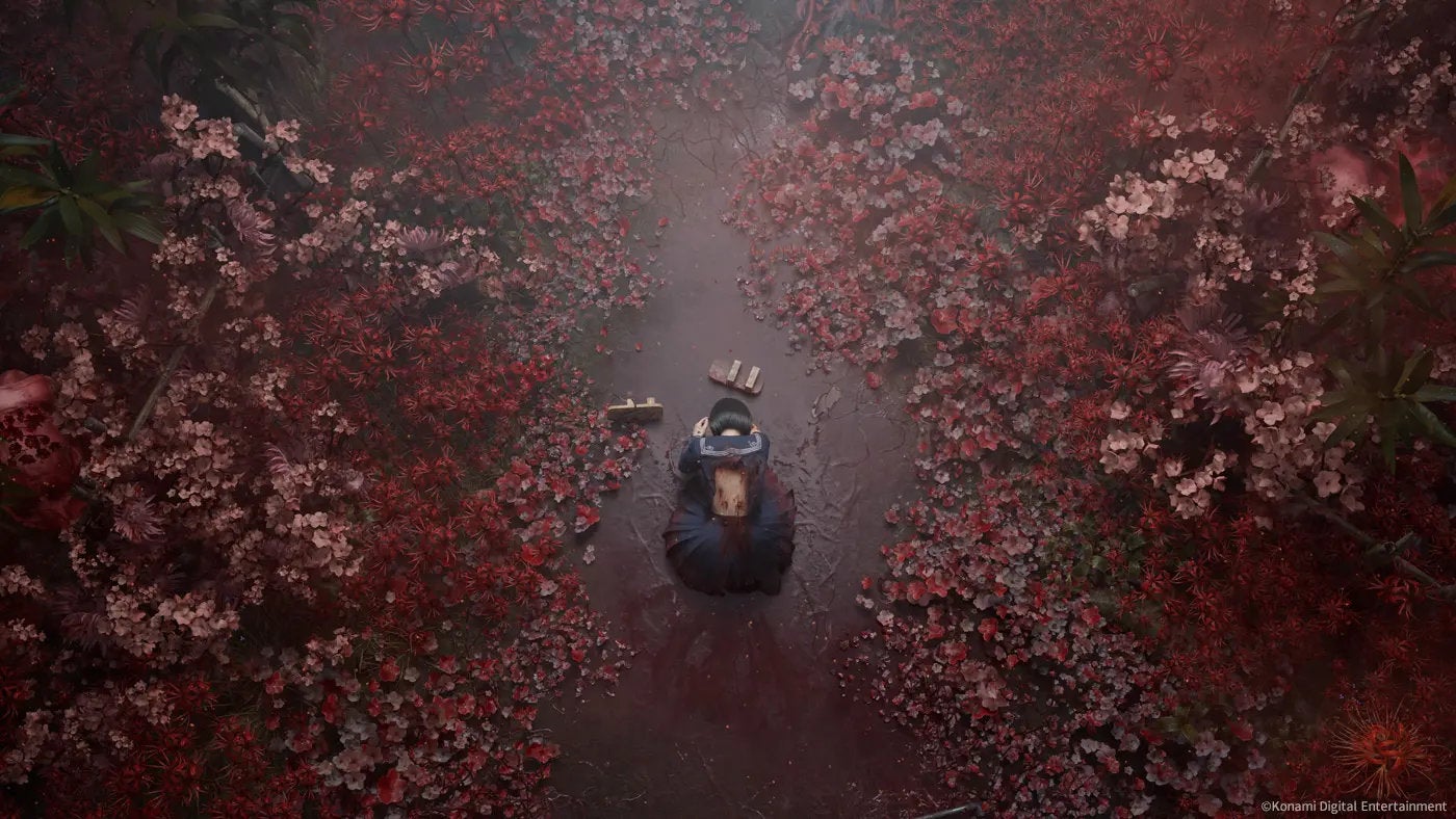 Hinako kneels surrounded by red flowers in Silent Hill f.