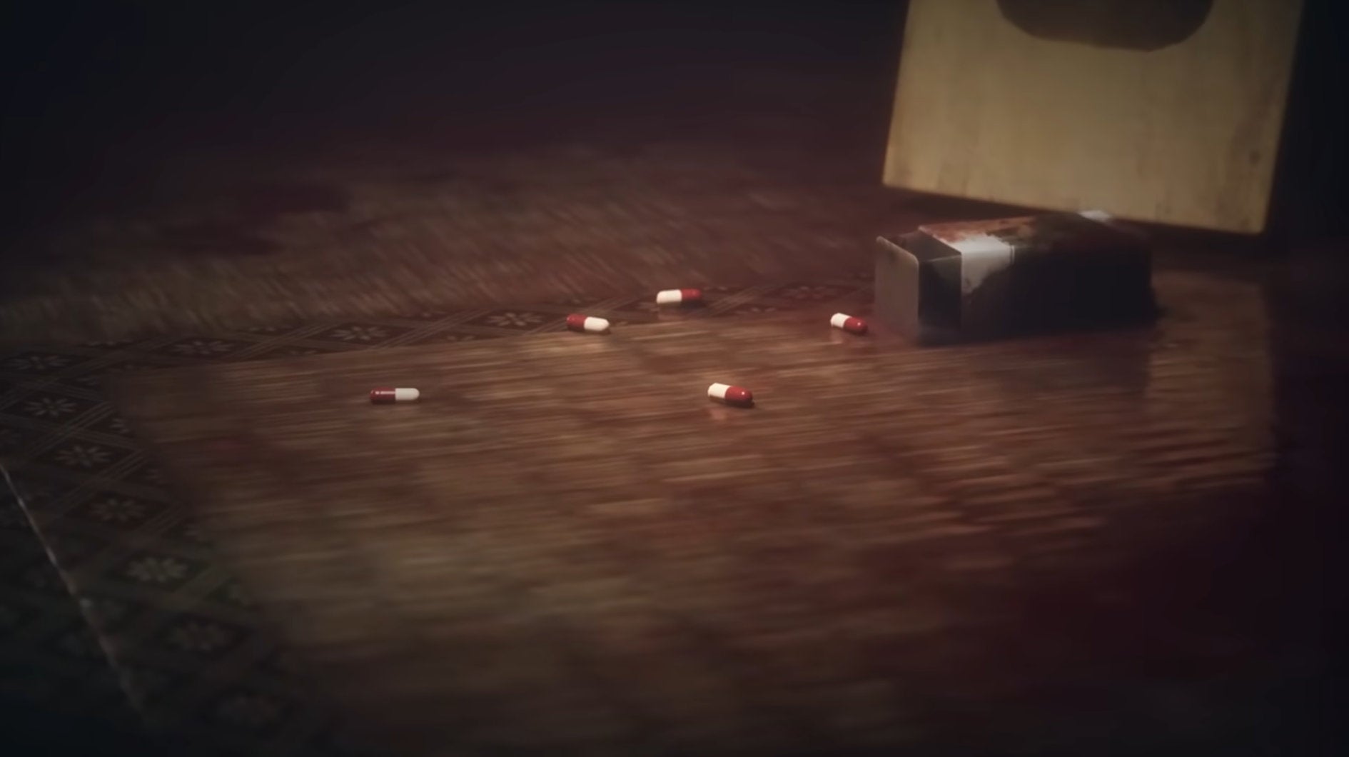 A close up of a bottle of pills, with some of the pills on the ground.