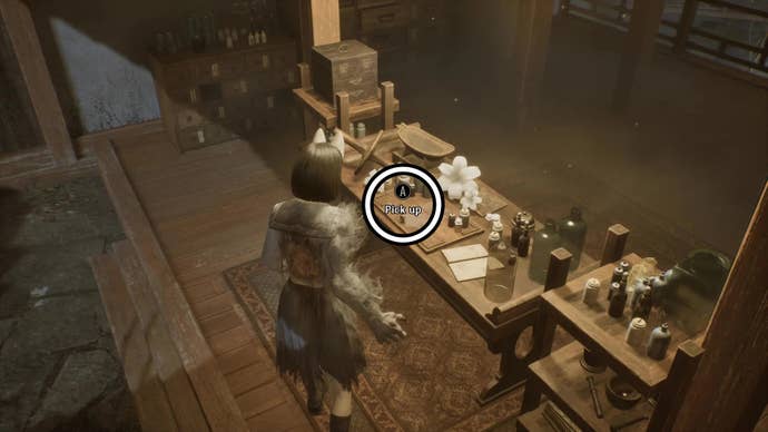 Picking up an item from a table in Silent Hill f.