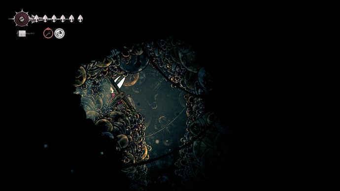 Hornet stands by some wooden beams that can be destroyed in Bellhart in Hollow Knight: Silksong