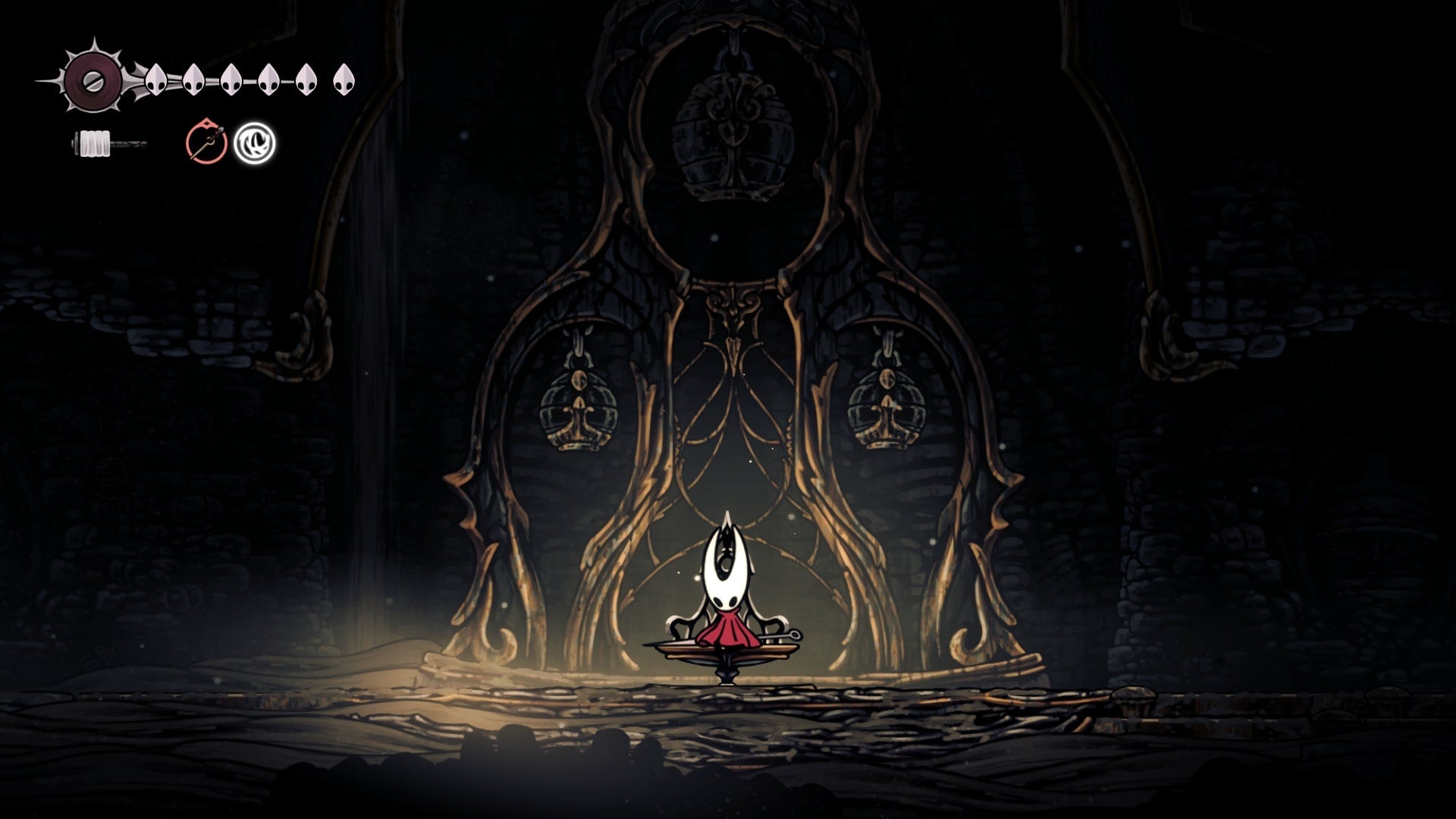 Hornet sits on the Bench in Blasted Steps in Hollow Knight: Silksong