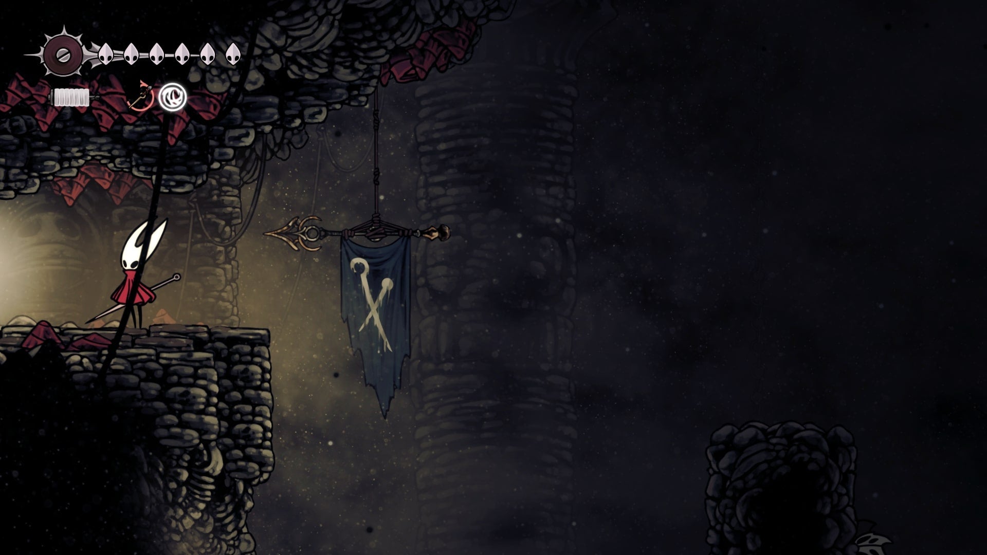 Hornet stands near an exit marked by a flag in Blasted Steps in Hollow Knight: Silksong