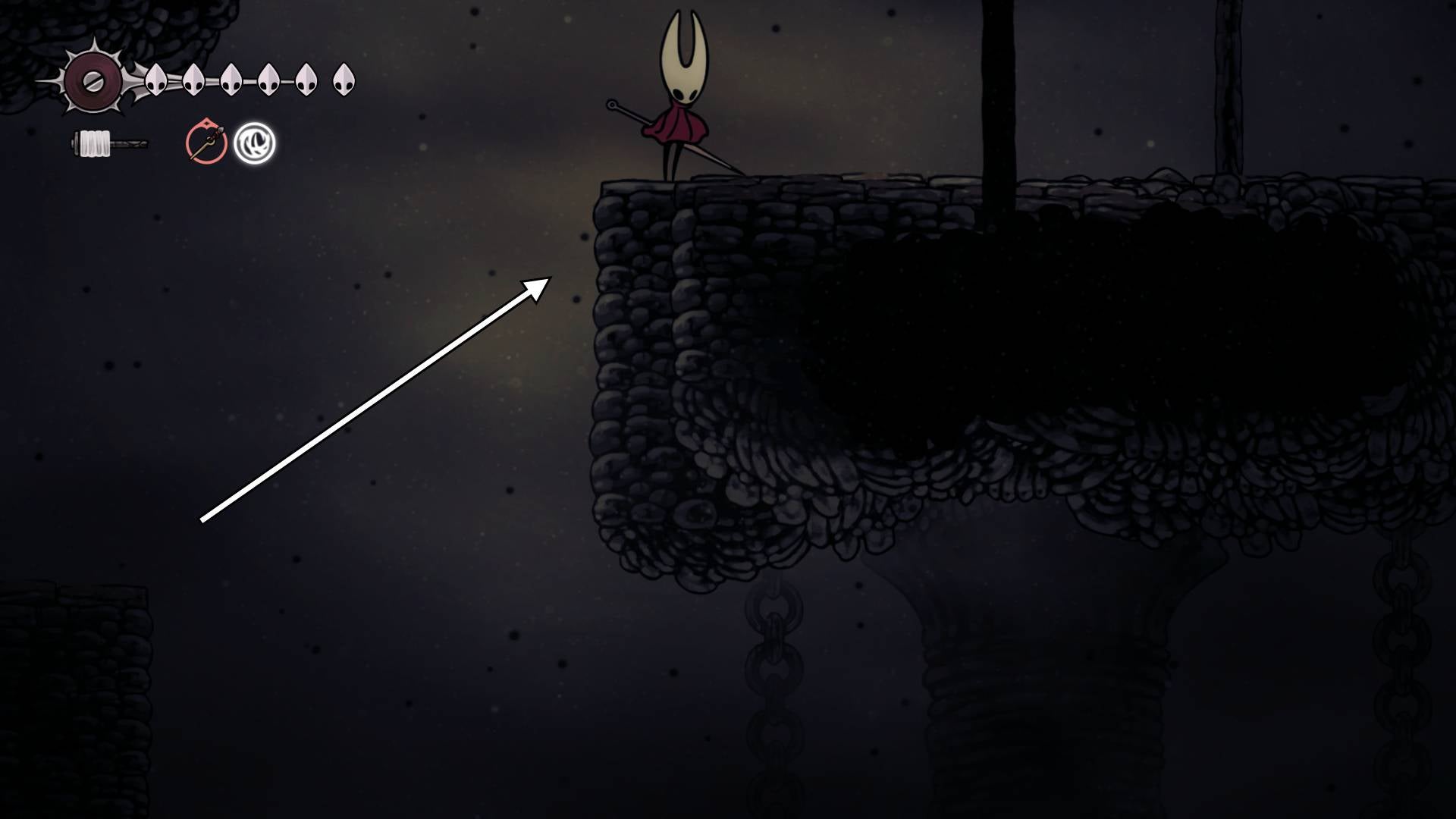 Hornet stands on a stone platform in Blasted Steps in Hollow Knight: Silksong