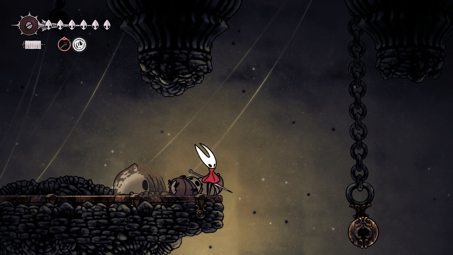 Hornet stands on a stone platform beside a bell in Blasted Steps in Hollow Knight: Silksong