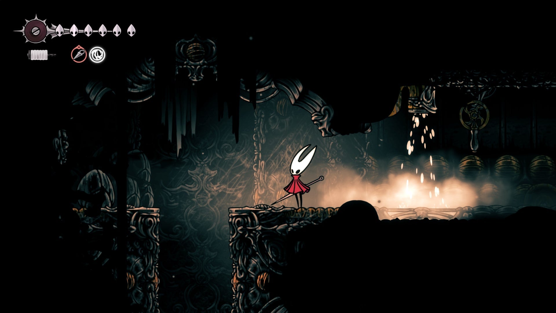 Hornet stands beside where a cage is usually hanging from a chain in Choral Chambers in Hollow Knight: Silksong