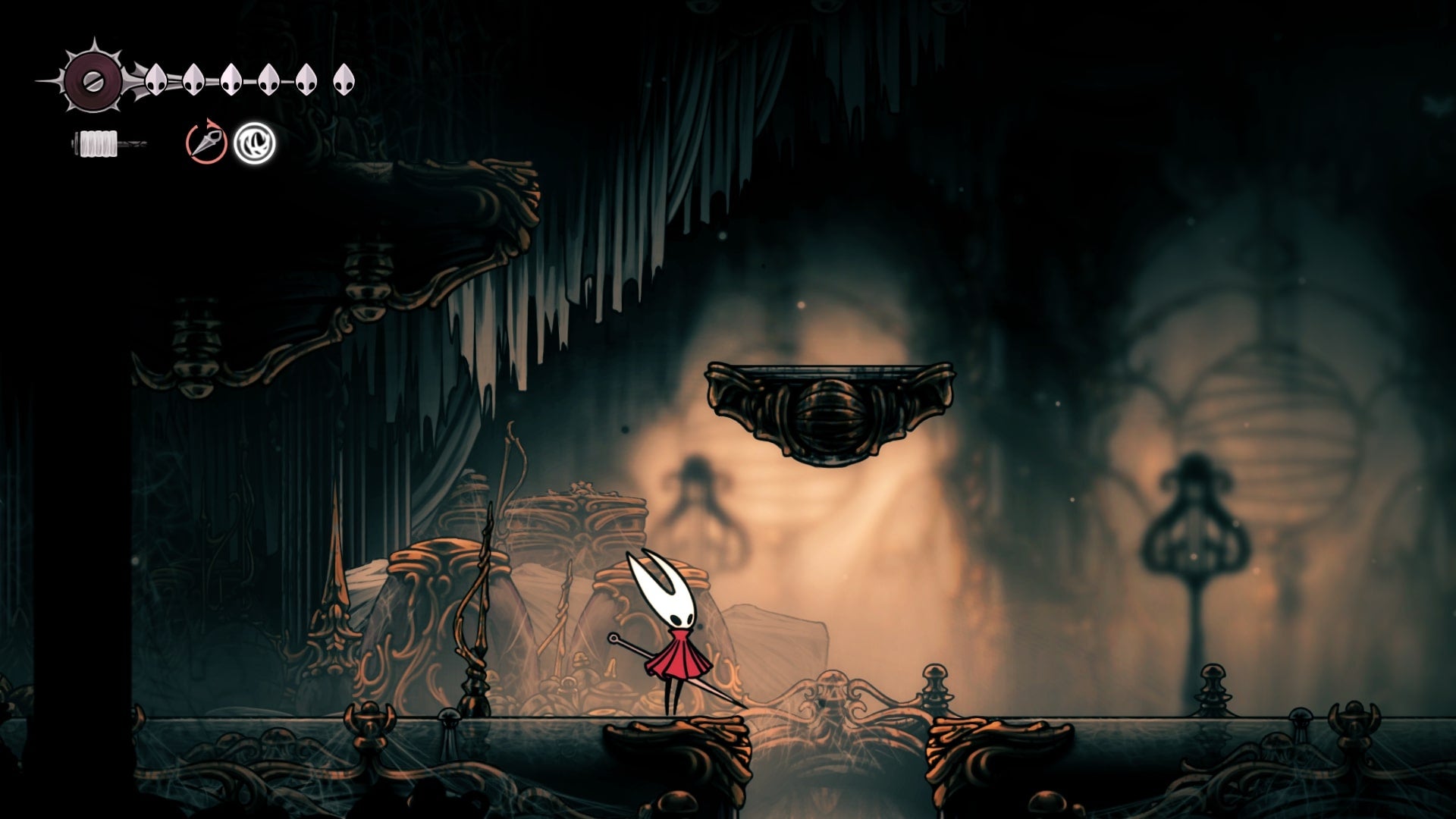 Hornet stands beside an exit beneath a platform in Choral Chambers in Hollow Knight: Silksong