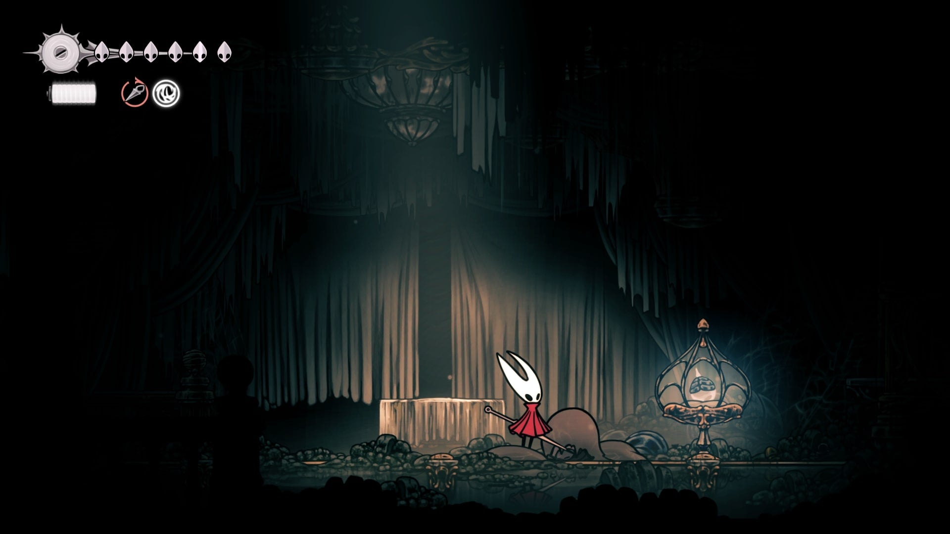 Hornet stands beside some Pale Oil inside of a glass ornament in Choral Chambers in Hollow Knight: Silksong