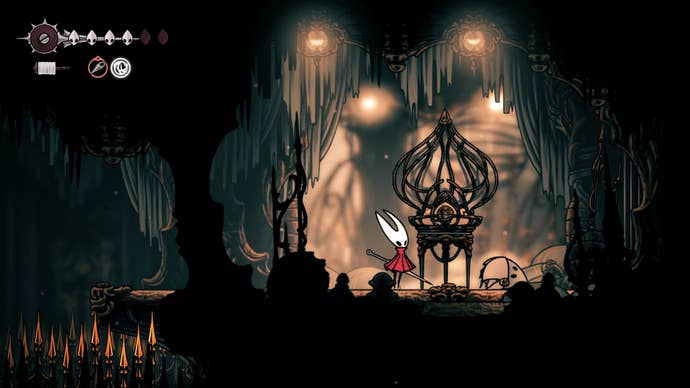 Hornet stands beside a cage containing a Flea in Choral Chambers in Hollow Knight: Silksong