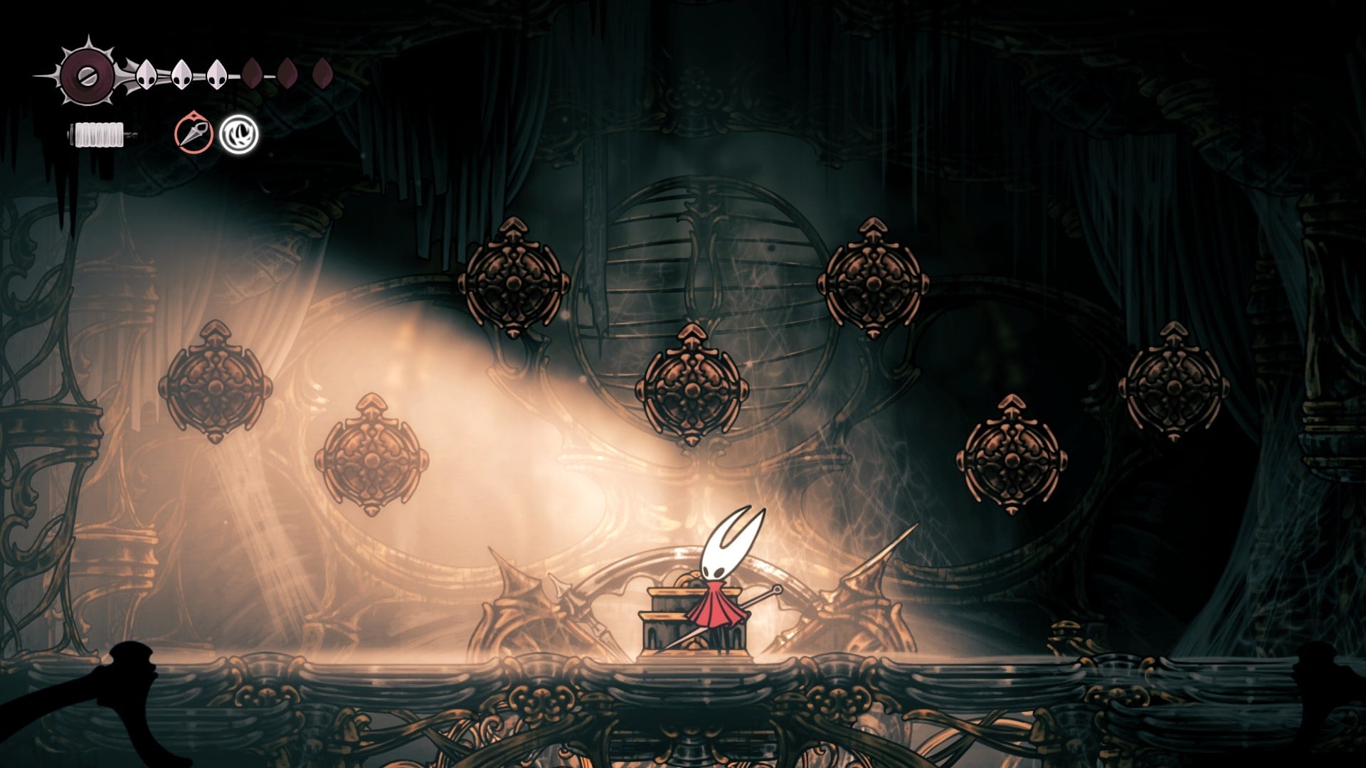 Hornet stands in a room with multiple bells in Choral Chambers in Hollow Knight: Silksong