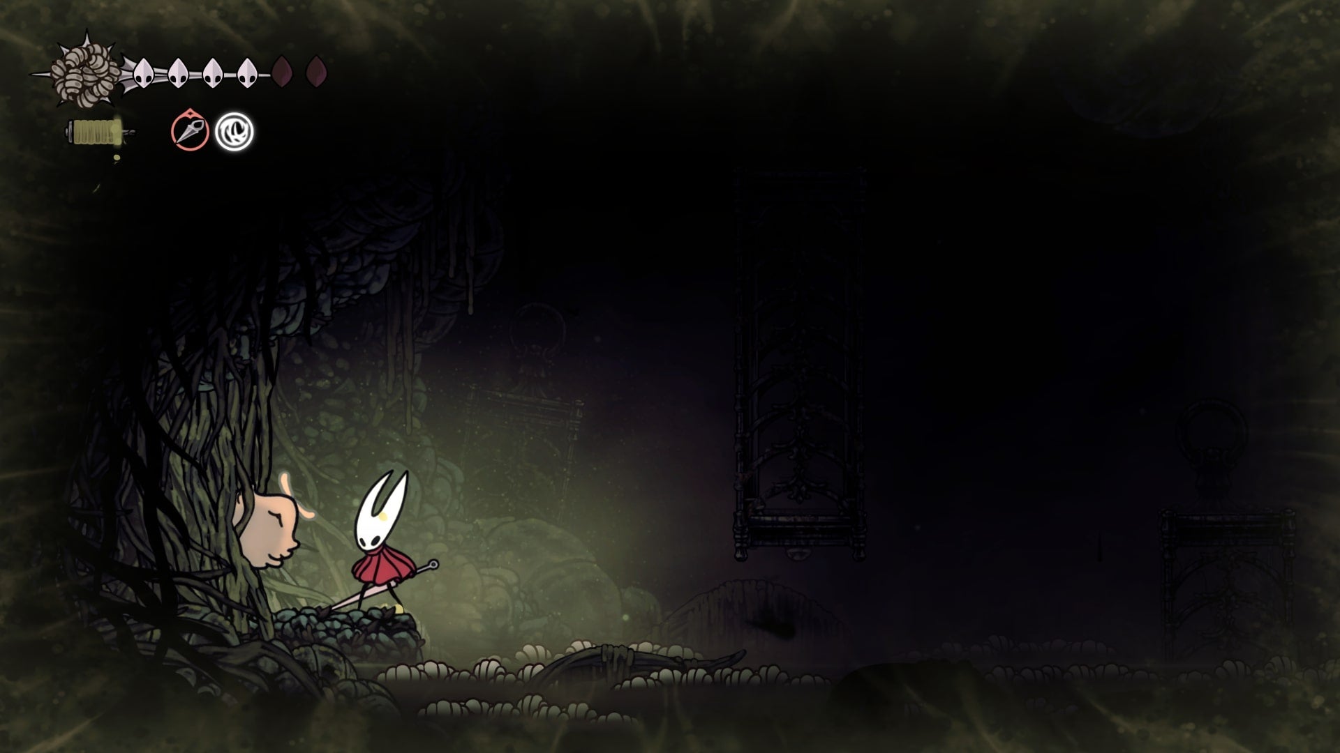 Hornet stands beside a trapped Flea in the Exhaust Organ in Hollow Knight: Silksong