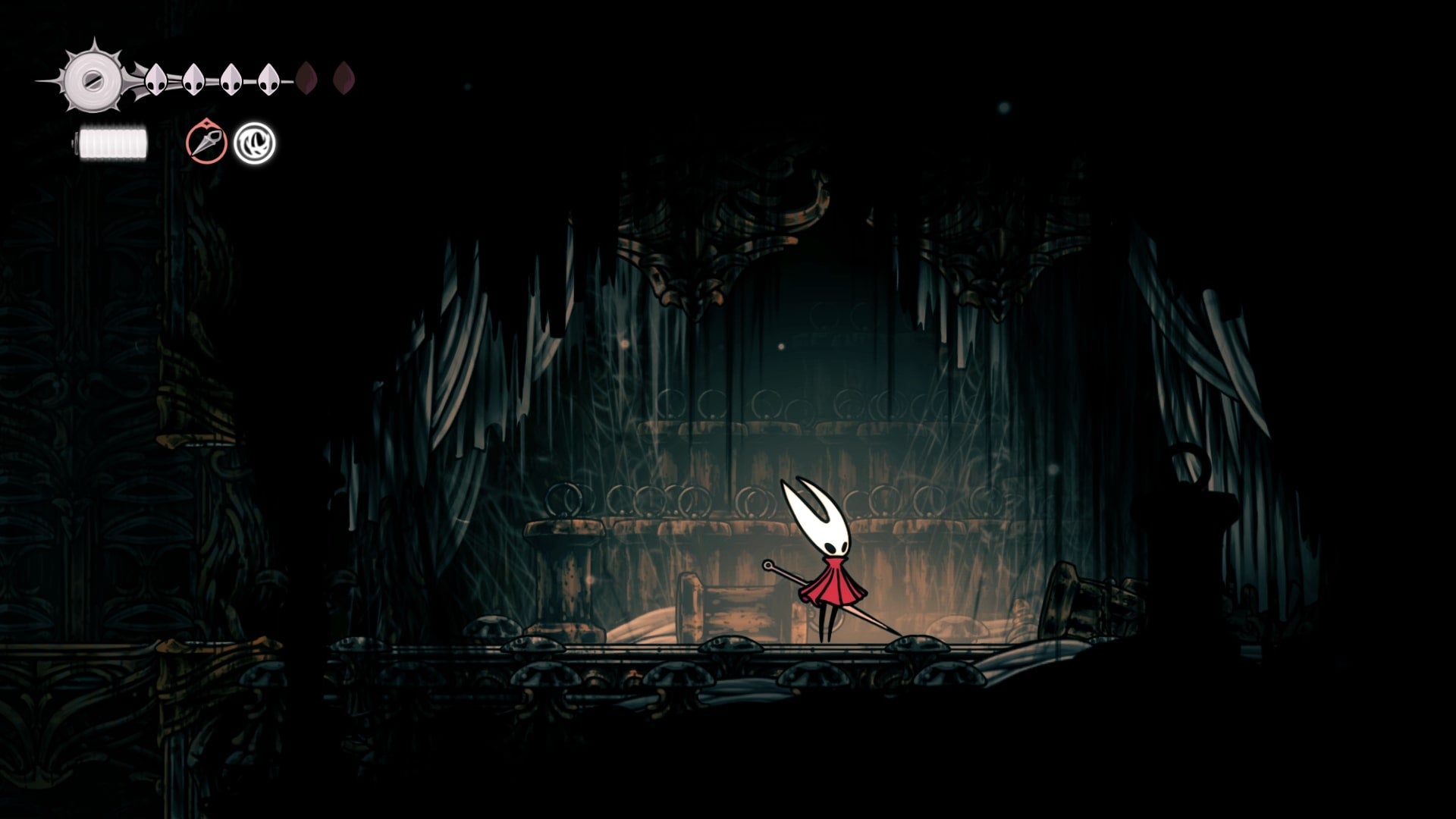 Hornet stands in a room of the Exhaust Organ where a Silkeater can be found in Hollow Knight: Silksong