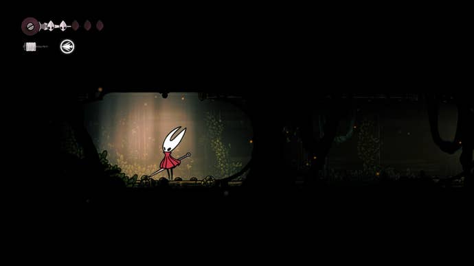 Hornet stands in a small room that leads to the Warding Bell in Far Fields in Hollow Knight: Silksong