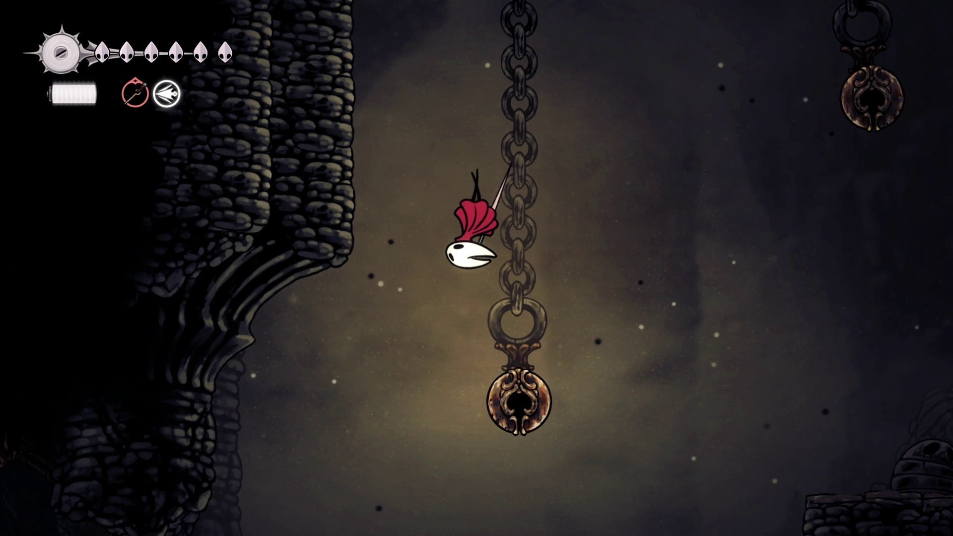 Hornet dives towards a Bell she can pogo off of in Blasted Steps in Hollow Knight: Silksong