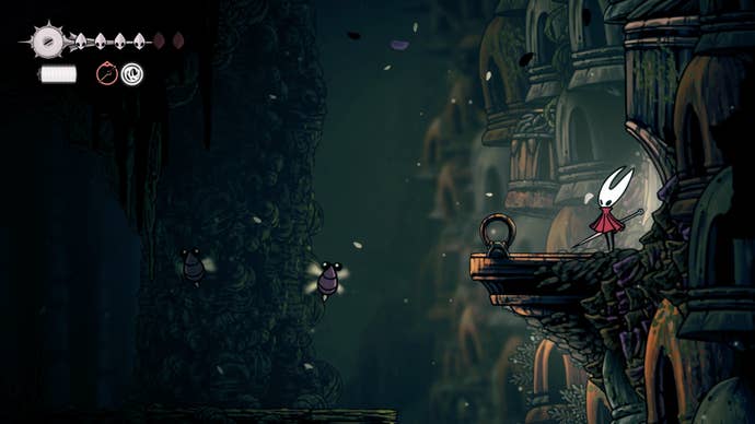 Hornet stands where a purple flower normally is - blocking a hidden chamber - in Shellwood in Hollow Knight: Silksong