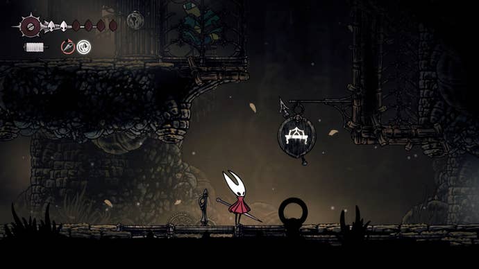 Hornet stands beneath a Bench sign in Sinner's Road in Hollow Knight: Silksong