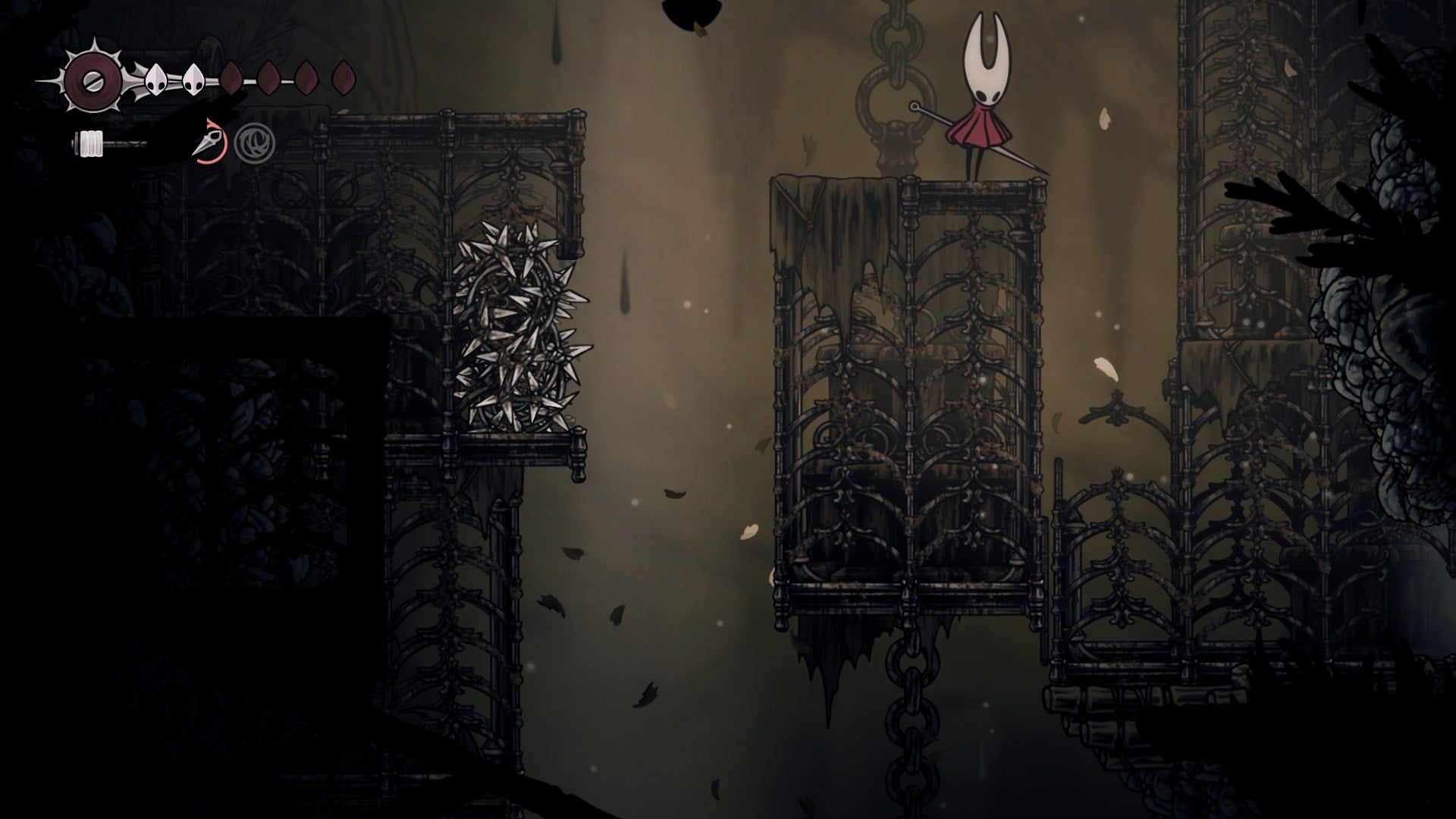 Hornet looks down at a broken cage that leads to an exit in Sinner's Road in Hollow Knight: Silksong
