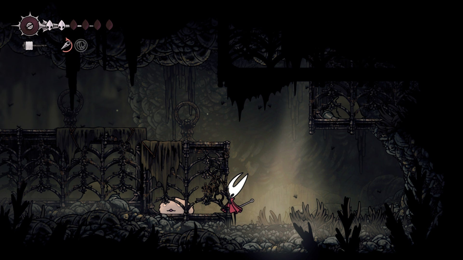 Hornet stands beside a trapped Flea in Sinner's Road in Hollow Knight: Silksong